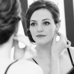 19-woman_wearing_earring_in_front_of_mirror